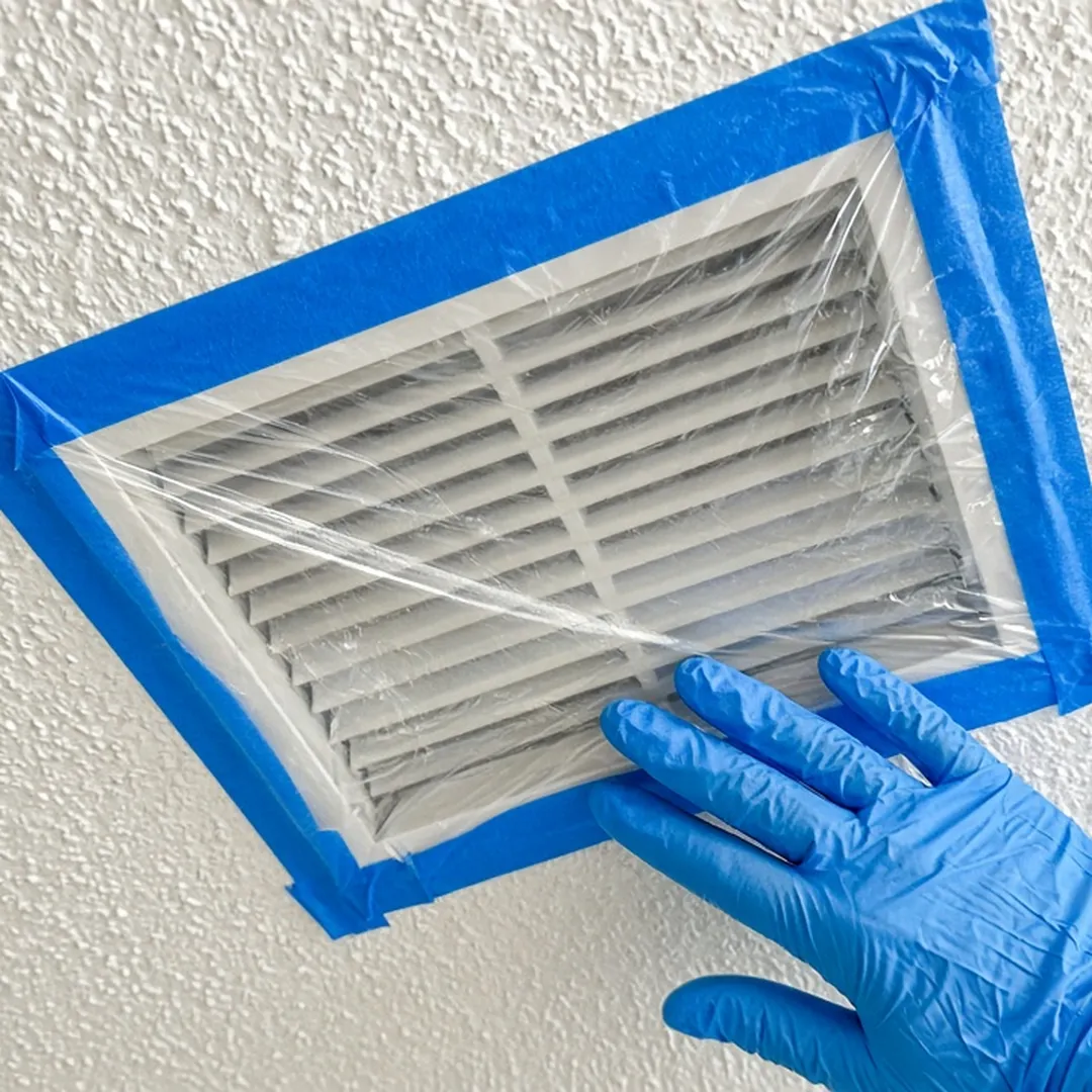 Ceiling air register covered with plastic and tape to contain odor during death cleanup